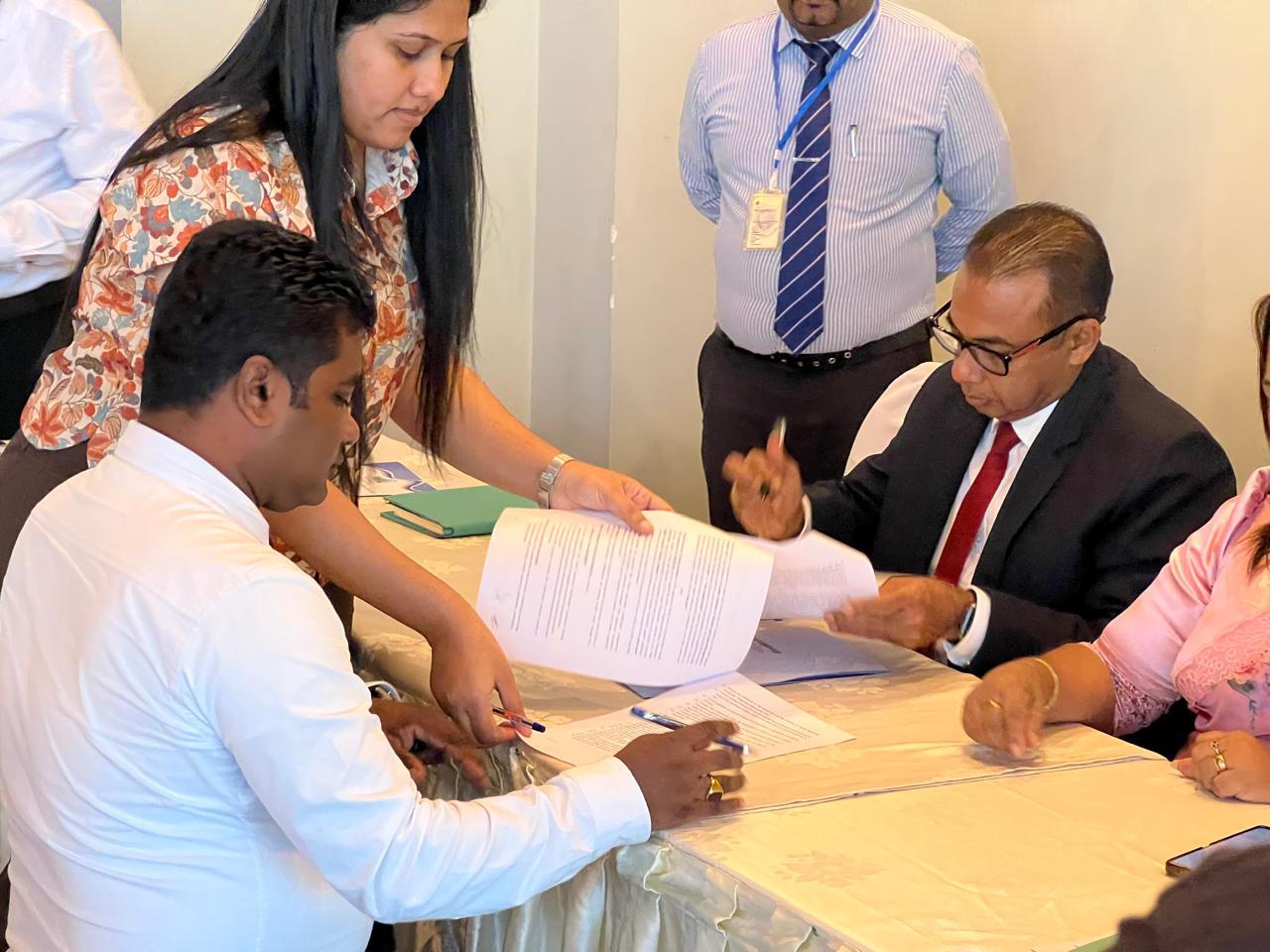 Officials signing the NVQ Level 3 programme agreement